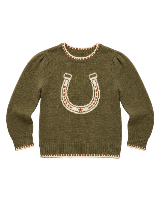 An olive green knit sweater with a large horseshoe motif in cream and rust-orange on the chest, finished with matching cream and rust trim at the collar, cuffs, and hem, laid flat on a light beige background.