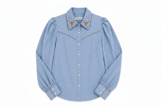A light blue denim long-sleeve western-style shirt with gold embroidered details on the collar and chest, shown flat against a white background.