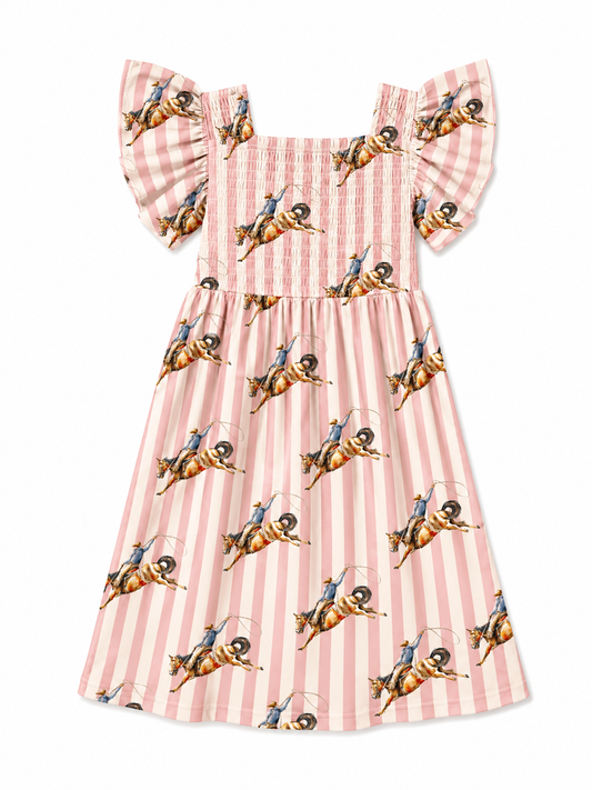 A pink and white striped dress with a repeating print of cowboy riders on horseback, featuring ruffled shoulder straps and a smocked bodice.